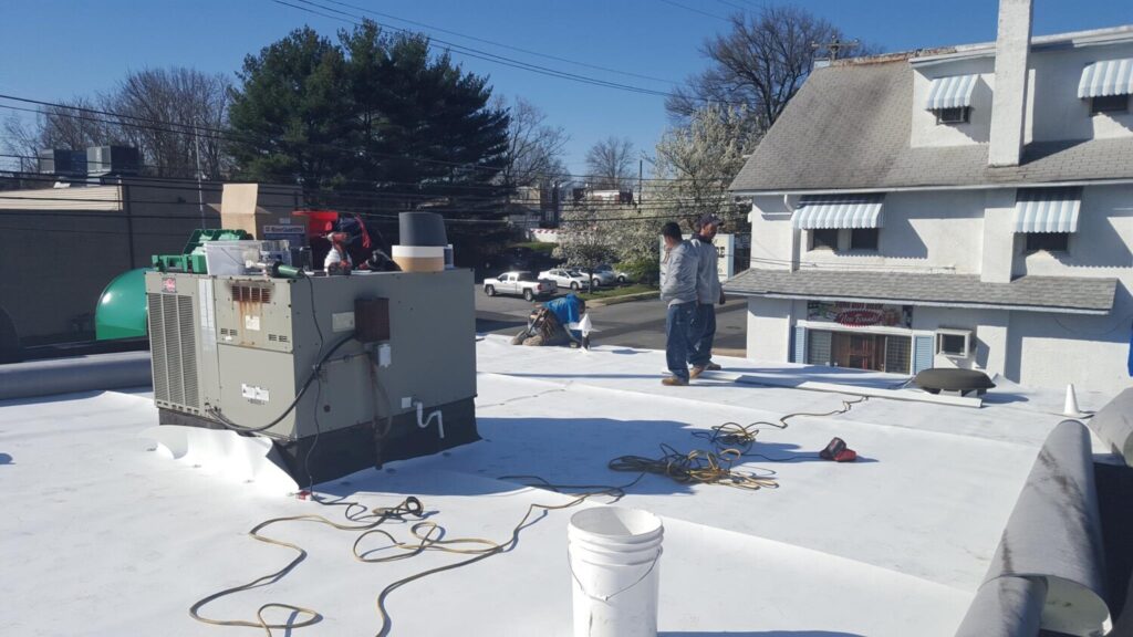 G Cannon roofing team working on a TPO commercial roof