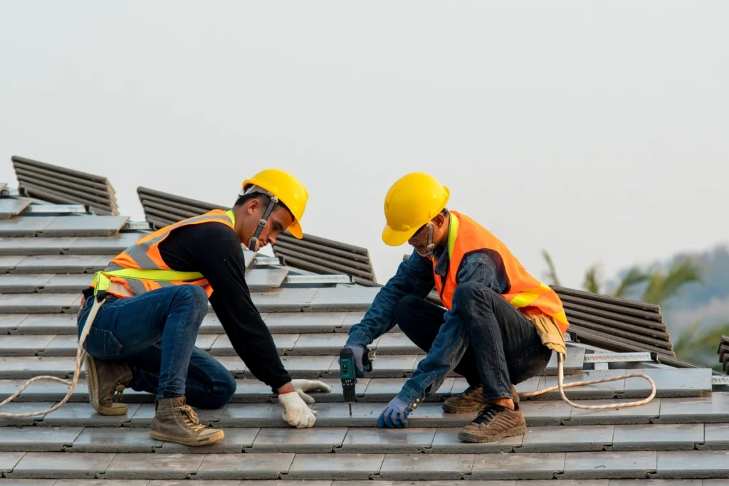 workers placing tiles on commercial roof