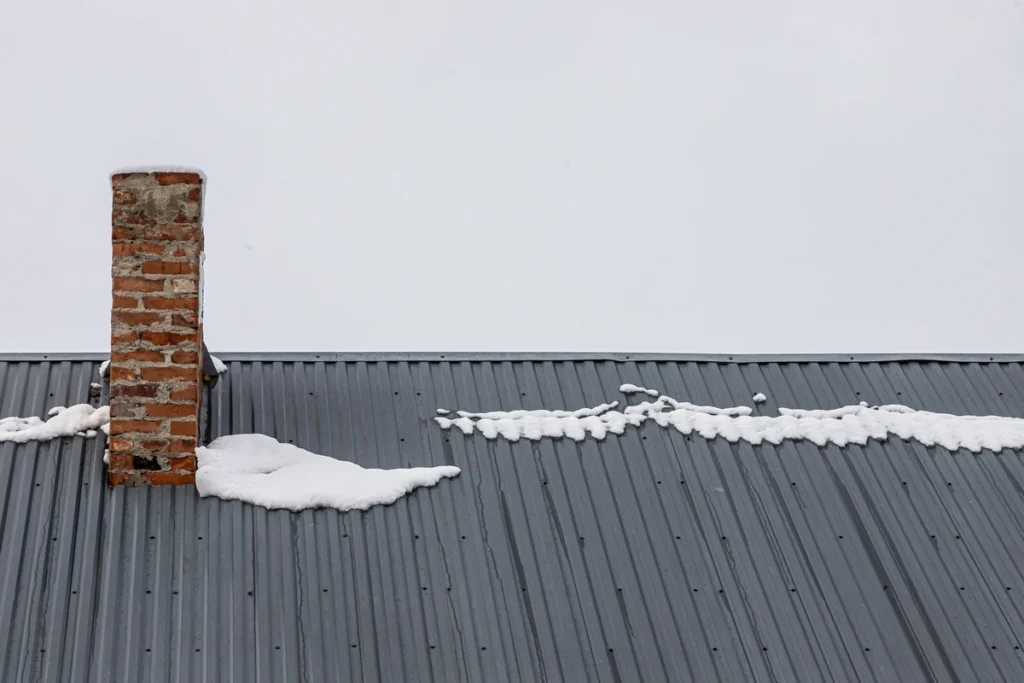 snow on a standing seam metal roof