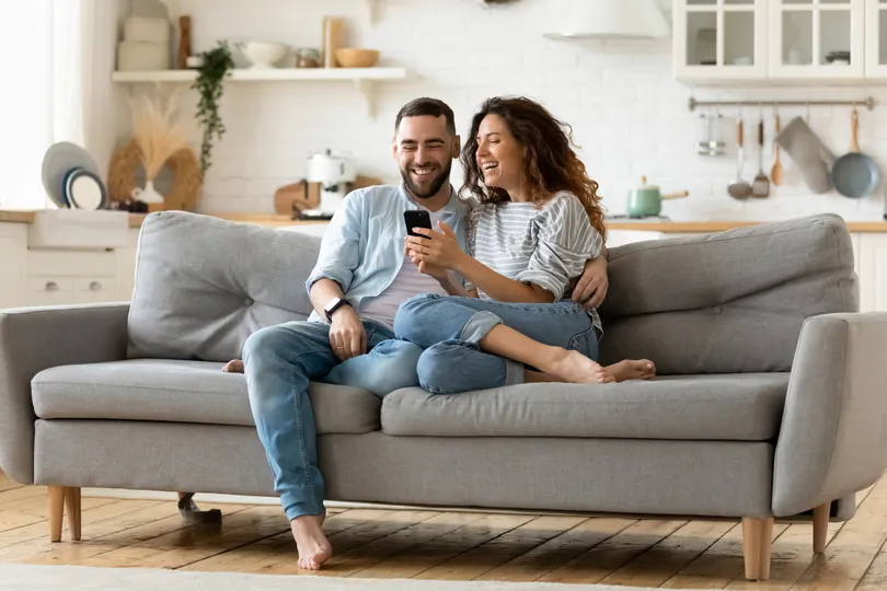 Homeowner couple sitting together on a couch in their home in Doylestown