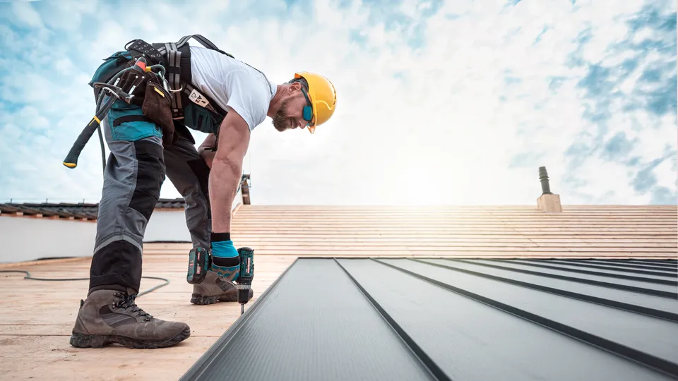 Commercial roofer working on a roof in Horsham
