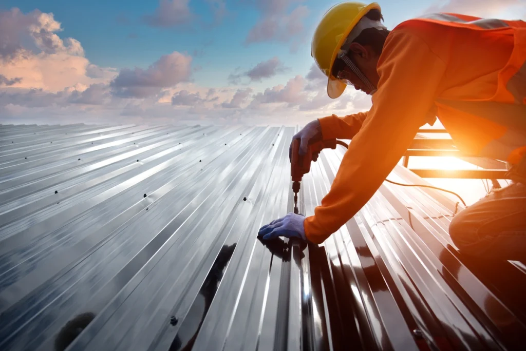 man using nail gun on commercial roof