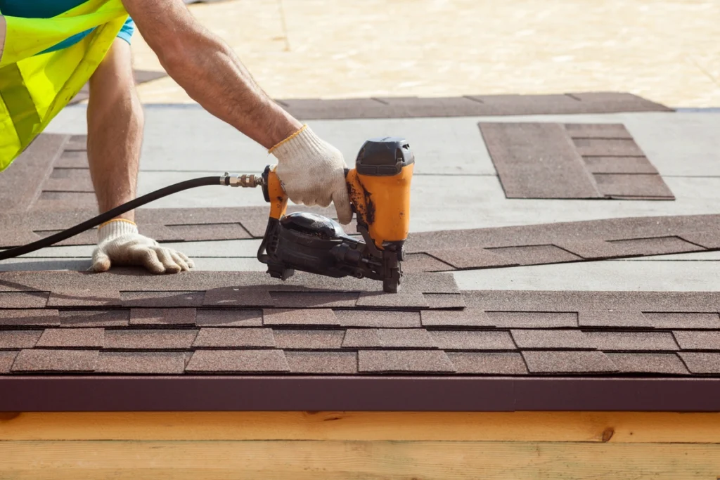 close up to roofer nailing shingles