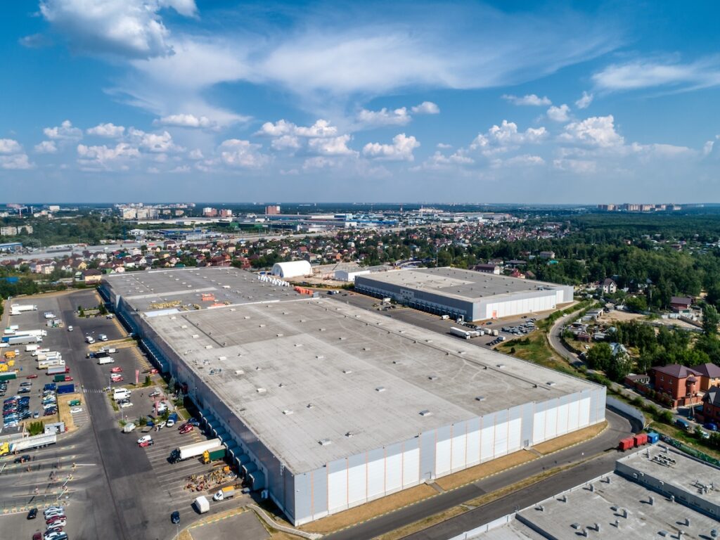 Aerial view of a large industrial warehouse complex with multiple buildings featuring flat roofs