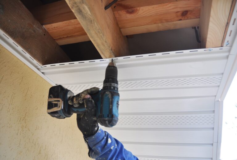 Roofer contractor installing on house roof new Soffit and Fascia. Roofing Construction. Soffit, Fascia installation.